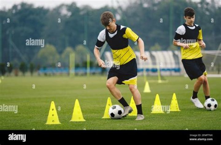 Can a goalie dribble the ball into the box and pick it up?