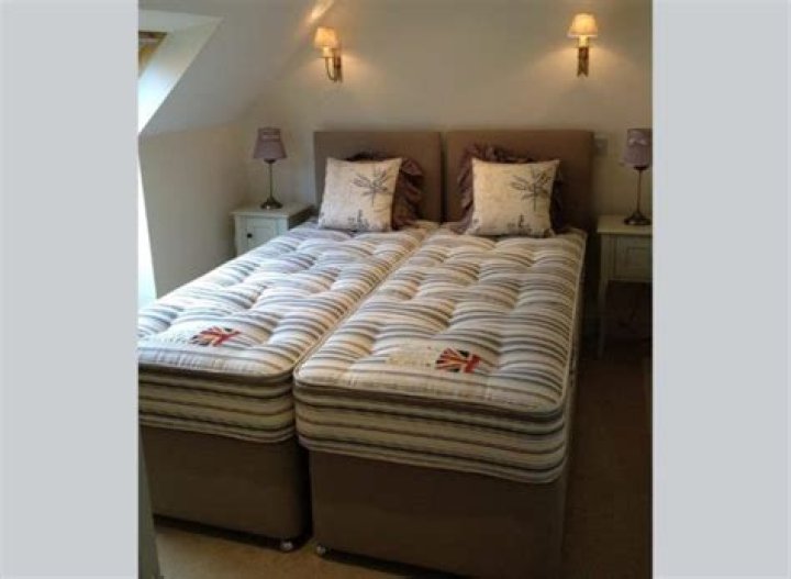 Can you put 2 single mattresses on a king bed?