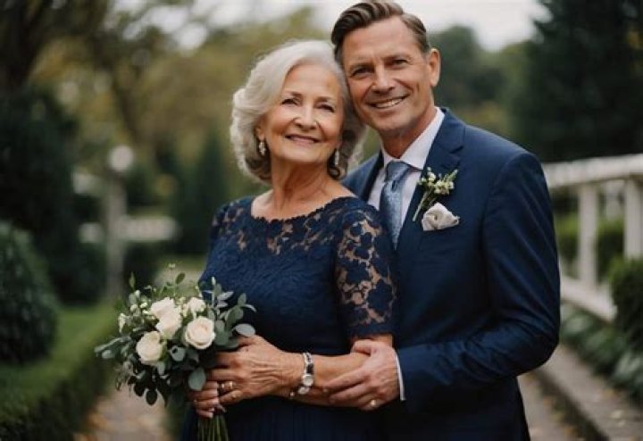 Does the groom's mother wear a hat?