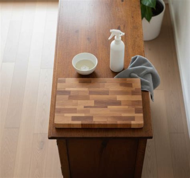 How do you disinfect wood furniture without damaging the finish?