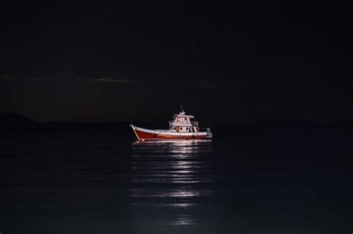 How do you pass a boat at night?