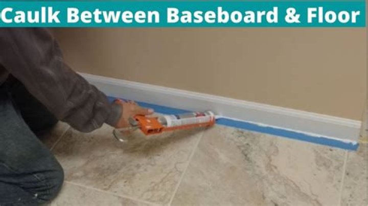 Should you caulk between tile and baseboard?