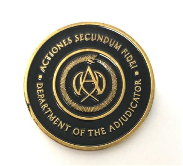 What does the adjudicator's coin say?