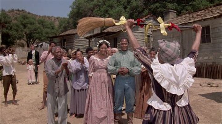 What is the tradition of jumping the broom?