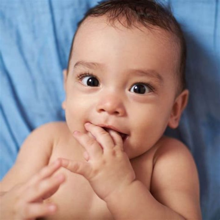 Why do babies cover their face with their hands?