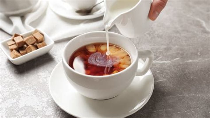 Why do British people drink tea with milk and sugar?