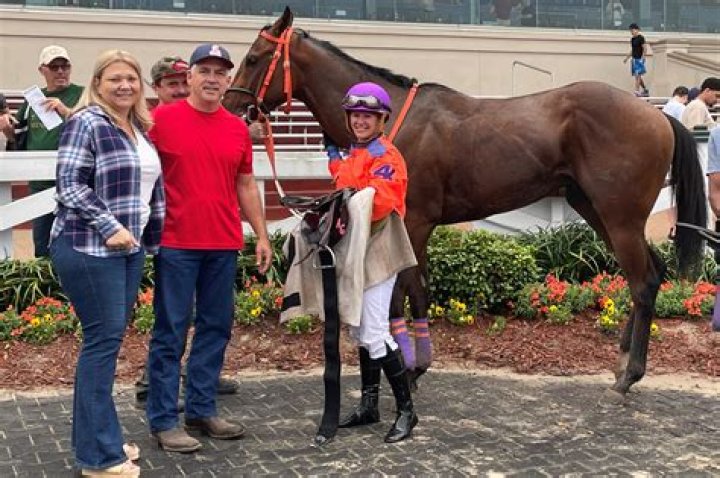 Why do horse jockeys stand up?