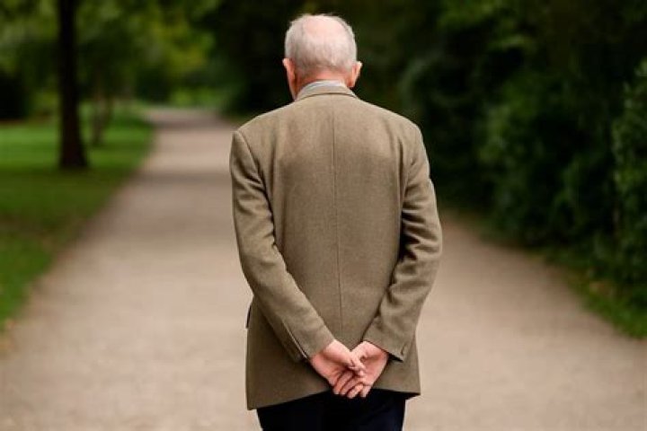 Why do royals walk with hands behind back?